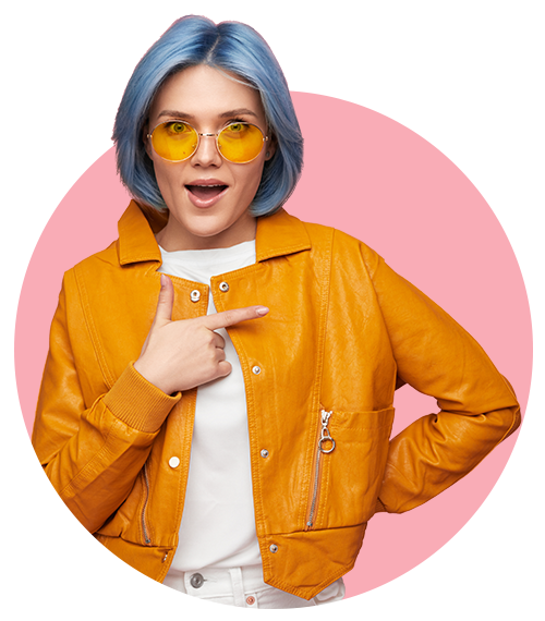 Excited young woman with blue hair wearing a yellow leather jacket and sunglasses pointing a finger on a transparent background