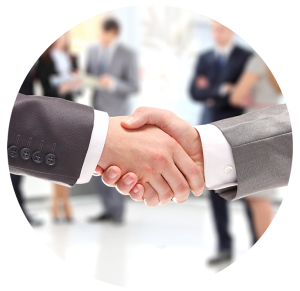 A close-up photograph of two businessmen in suits shaking hands firmly, symbolizing a business agreement or successful partnership.