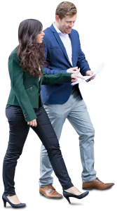two professional business colleagues in suits walking and reviewing documents together